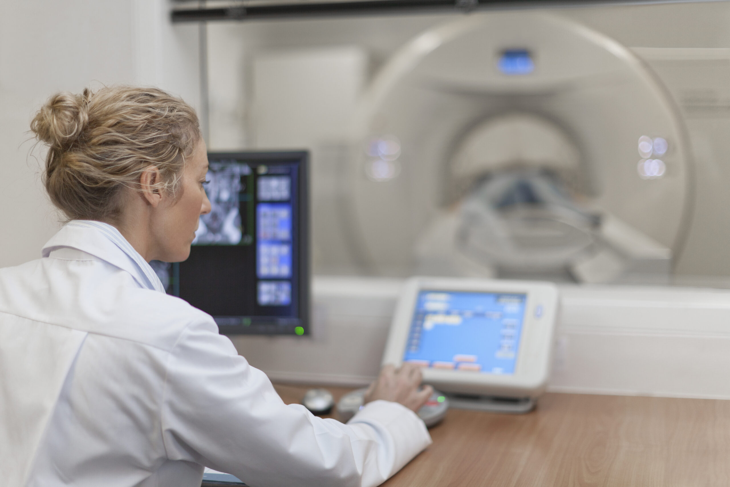 Woman at MRI Machine controls